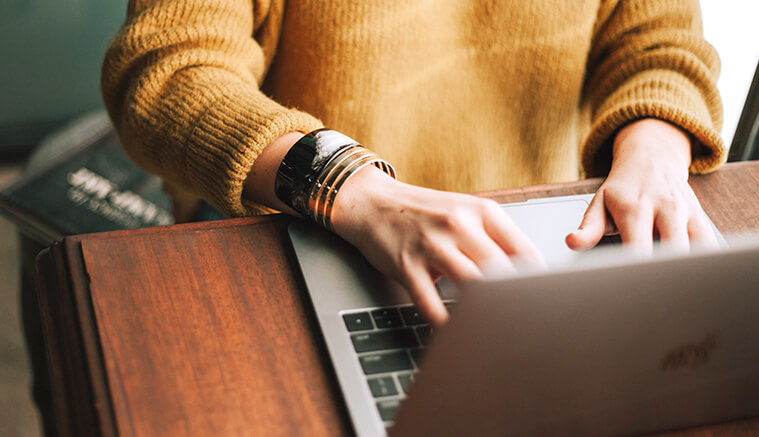 Female checking her business checking account on laptop