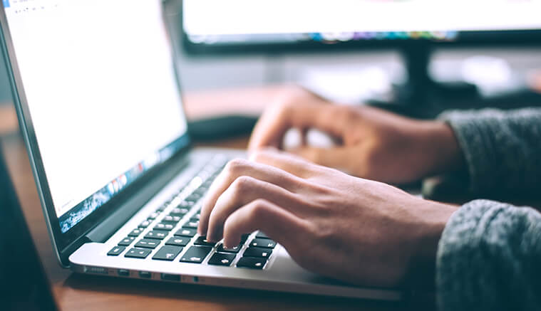 Man typing on laptop