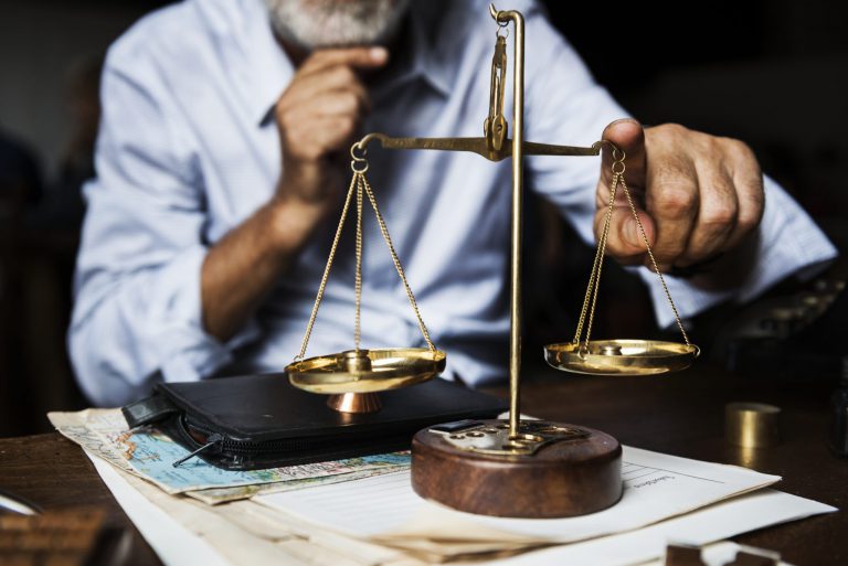 older man using a vintage scale thinking about buying insurance on a budget