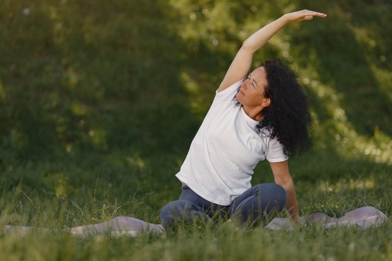 woman sitting outside doing yoga enjoying retirement