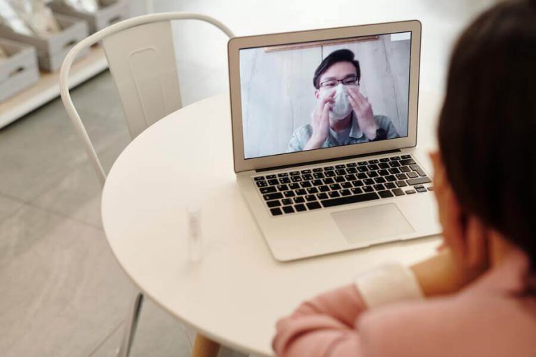 Woman talking to doctor through video call.