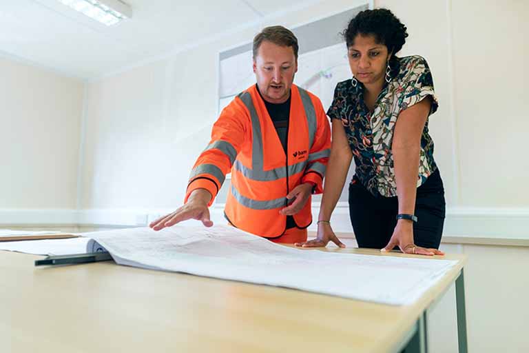 Architect and contractor looking at blueprints