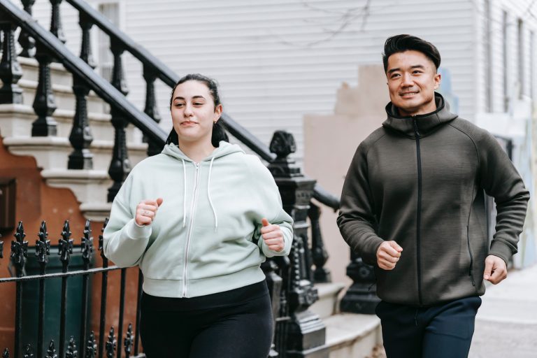 Asian man and female running for exercise outside
