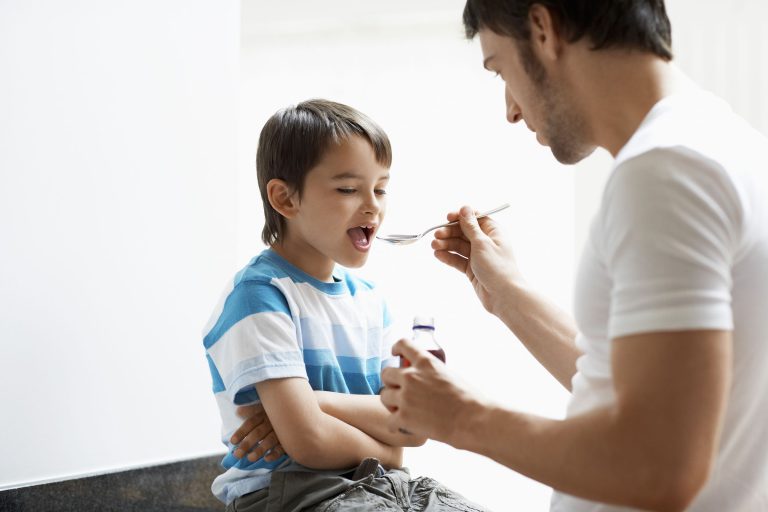 father giving son discounted prescription cough medicine