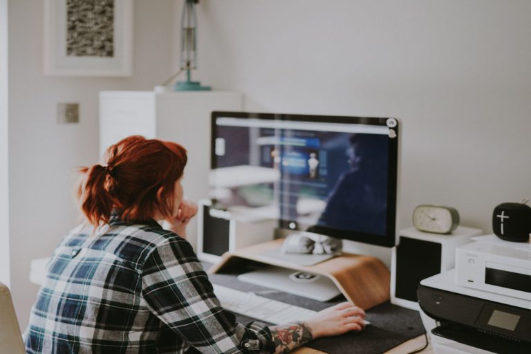 self employed female researching how medical insurance works on her computer