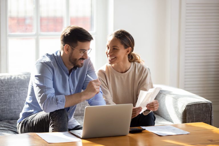 Young newly married couple learning about insurance premium tax credits