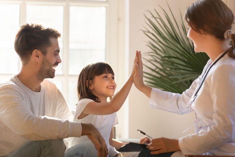 father with daughter at pediatrician appointment using short term health insurance to pay for visit