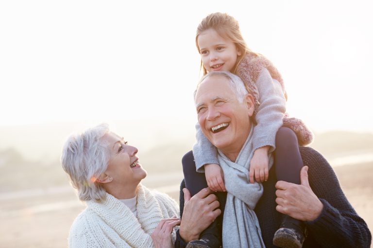 grandmother and grandfather playing with granddaughter