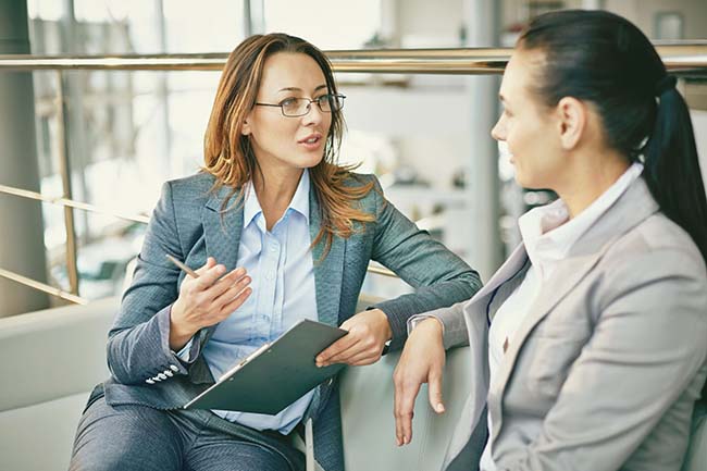 Two women discussing how accident insurance works