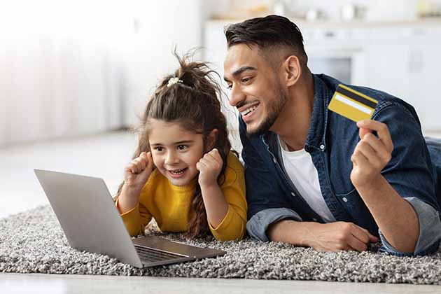 Middle Eastern father making online purchase for daughter