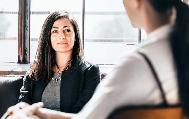 Female consultant sitting with female client