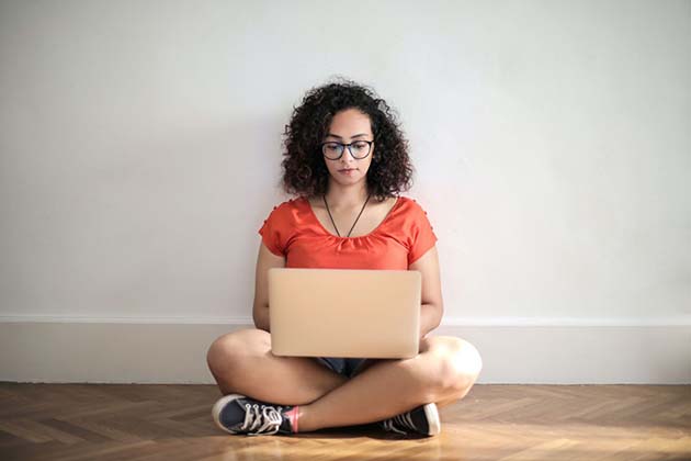 Female receiving online therapy on laptop